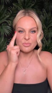 Belle Brett demonstrating the EFT tapping point at the side of the eye